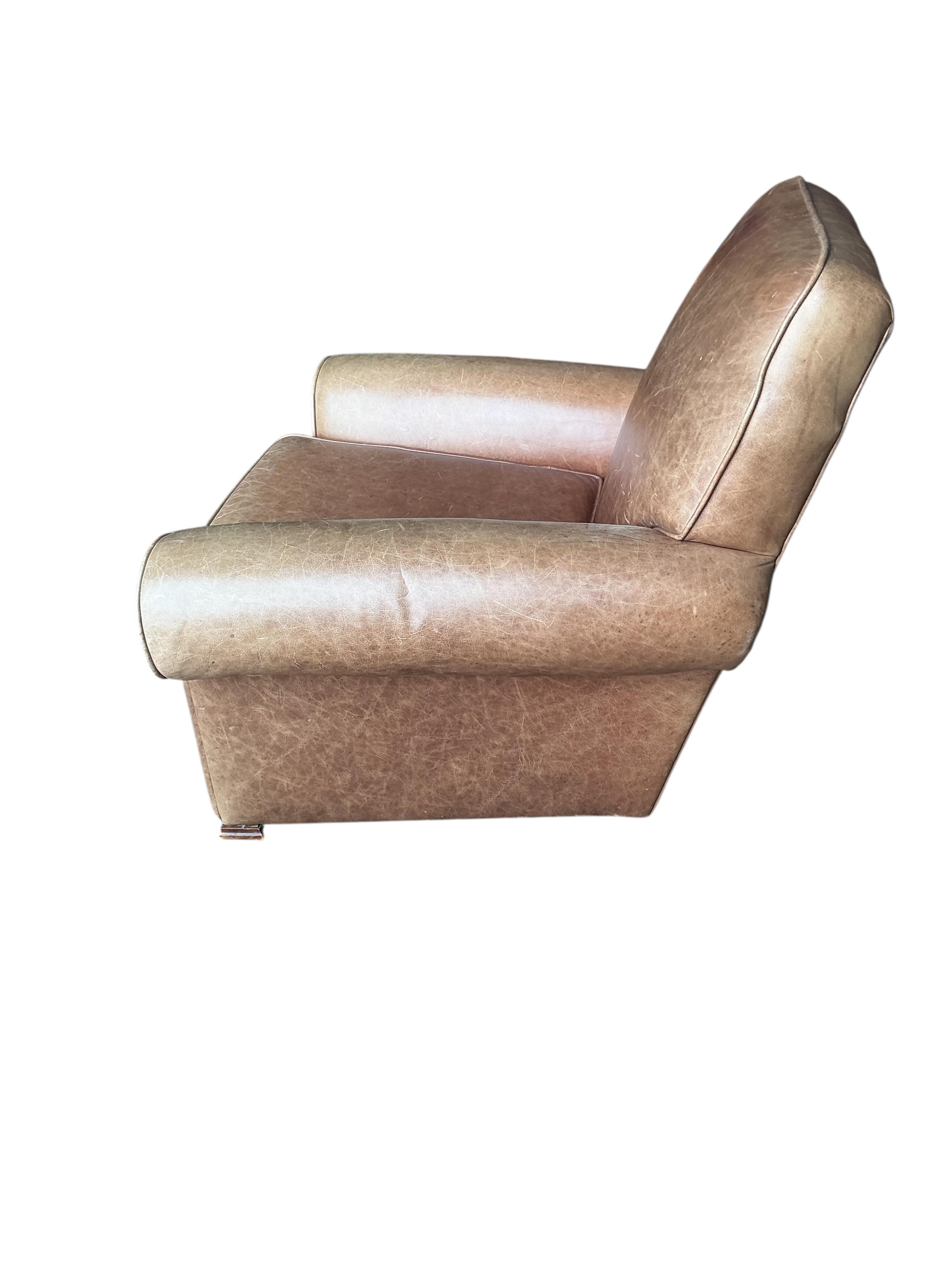 A pair of early 20th century tan leather club chairs, width 94cm, depth 78cm, height 80cm